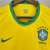 Camisa amarela da Seleção Brasileira, modelo 20/21, com logo da CBF e detalhes em verde.