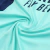 Close-up of the Arsenal 2024/2025 training kit fabric in green and blue, featuring smooth texture and subtle sheen.