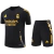Real Madrid 2024/2025 training kit featuring a black jersey and shorts with yellow accents and the Emirates logo.