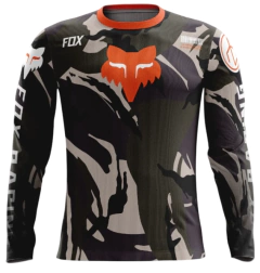 Jersey de motocross Fox Racing en diseño camuflado con tonos negros, marrones y detalles naranjas