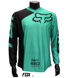 Jersey FOX 180 verde y negro, diseño moderno y aerodinámico para motocross y BMX.