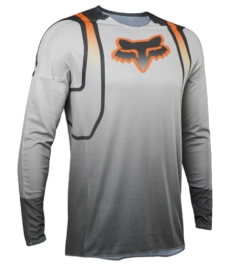 Jersey de motocross Fox Racing en gris con detalles en naranja y mangas largas, ideal para alto rendimiento.

