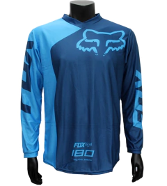 Jersey FOX 180 azul oscuro y celeste, diseño moderno y aerodinámico para motocross y BMX.