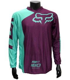 Jersey FOX 180 morado y celeste, diseño moderno y aerodinámico para motocross y BMX.