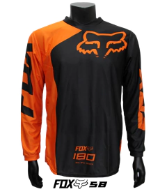 Jersey FOX 180 negor y naranja, diseño moderno y aerodinámico para motocross y BMX.