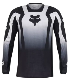 Jersey Fox 180 Lean en color negro, diseñado para motocross y enduro, con tejido transpirable y ajuste ergonómico.