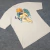 Camiseta Oversized Tam. GG Malhão Grosso Trip Side Cor Creme Estampa do Anjinho Original