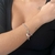 PULSEIRA DUPLA COM PINGENTES DA SORTE FOLHEADO EM R