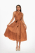 Vestido midi en color moca con detalle de lazo en el escote y falda de volantes. Mod. Leyre sku. 34810