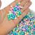 bolinhas coloridas de 8mm, com diversas cores, incluindo azul, rosa, verde e amarelo, sobre um fundo de outras bolinhas.