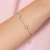 Pulseira com letrinha cravejada e flor banho de ouro 18k - loja online