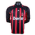 Camisa de futebol do AC Milan, modelo retro de 2006, fabricada pela Adidas, com mangas longas e listras vermelhas e pretas.