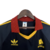 Camisa retro azul marinho da AS Roma de 1991, com detalhes em vermelho e amarelo, e logotipo da Adidas.