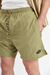 Short de baño liso "Crushed", confeccionado en nylon bomber, con bordado a contratono y cordones jaspeados, disponible en verde, gris, mostaza y negro.