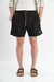 Short de baño liso "Crushed", confeccionado en nylon bomber, con bordado a contratono y cordones jaspeados, disponible en verde, gris, mostaza y negro.