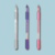 Canetas gel Inkfinity em cores pastel: cinza, roxa e rosa, com ponta de 1.0mm, apresentadas em cartela com 3 unidades.