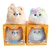 Duas pelúcias interativas da linha Huggy Pets, uma em forma de cachorro e outra em forma de gato, dentro de suas caixas, com olhos brilhantes e expressões fofas.