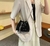 Cartera de mujer importada de gamuza con strass, ideal para fiestas, en color negro, llevada como bolso bandolera.