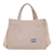 Cartera unisex de tela corderoy color beige con asas y correa ajustable.