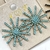 Brinco Ponteira Sol em Strass - 5 Cores
