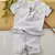 Conjunto Bata ou Body Branca Xadrez Veneza Burb e Bermuda Saruel Branca Índigo Trend