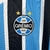 Camisa Grêmio Casa 23/24 - Versão Torcedora Feminina - Umbro - Azul com detalhes Listrados em Branco e Preto