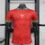 Camisa vermelha da seleção de Portugal, edição especial CR7 "The Siu" 2024/25, com detalhes em verde e o brasão da seleção em dourado.