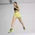 Mujer en movimiento usando zapatillas Puma Velocity Nitro 3 Psychedelic, con un conjunto deportivo brillante.