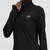 Buzo deportivo de mujer New Balance en color negro con cierre hasta el cuello y logo en el pecho.