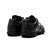 Botines Joma Score Micro para hombre, con diseño en color negro, vista trasera mostrando detalles de la textura y suela.