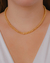 Colar Choker Bolinhas Lisas e uma Bola Cravejada no Dourado