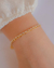 Pulseira Dupla Elos Cartier e Riviera de Baguetes no Dourado