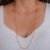 Colar Comprido Tubinhos Lisos com Zirconias Penduradas no Dourado