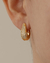 Brinco Argola U Cravejada de Microzirconias Menor no Dourado - comprar online