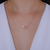 Colar Letra de Microzirconias com Zirconia Quadrada no Dourado com Rosa Claro