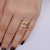 Anel Ondulado Trabalhado com Cristal Oval no Dourado com Roxo na internet