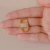 Pingente Oval com Microzirconias no Meio Estilo Soda Caps no Dourado com Cristal