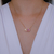 Colar Letra de Microzirconias com Zirconia Quadrada no Dourado com Rosa Claro