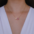 Colar Letra de Microzirconias com Zirconia Quadrada no Dourado com Rosa Claro - comprar online
