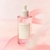 Ampolla de serum Poremizante Fres de 50 ml de SKIN1004, con envase transparente y tapa blanca, sobre fondo rosa.