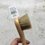 Cepillo de limpieza facial de Tiendas Green con mango de madera y cerdas suaves.