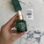 Botella de aceite facial antioxidante reparador de BEK, con gotero y etiqueta clara en un fondo marbled.