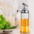 Aceitera de vidrio con tapa hermetica de metal 200 ml Codigo 49341 - Bazar 380