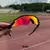 Óculos de sol esportivo Radar EV na cor Dark Ruby, com lente espelhada em tons de vermelho e amarelo e preto, acompanhado de uma case de proteção.