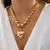 Collar de estilo punk con colgante de corazón de cuentas redondas