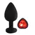 Plug anal de silicona mediano de color negro con un strass en forma de corazón rojo.