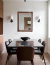 Rectangular LED mirror with a luminous oak frame, displayed above a dining table in a modern setting.