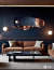Espejo ARD Glanz Cloud de 120 x 55 cm reflejando un salón moderno con sofá marrón y decoración minimalista.