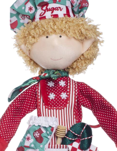 Muñeco de duende chef llamado "Sugar", con cabello rizado y vestido de cocina rojo con detalles navideños.