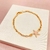 Pulseira elos cartier e pingente estrela do mar - banhada a ouro 18k